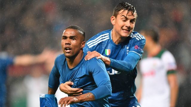 Juventus' Brazilian forward Douglas Costa celebrates with Juventus' Argentine forward Paulo Dybala after scoring a goal during the UEFA Champions League group D football match between FC Lokomotiv Moscow and Juventus at Moscow's RZD Arena stadium on November 6, 2019.