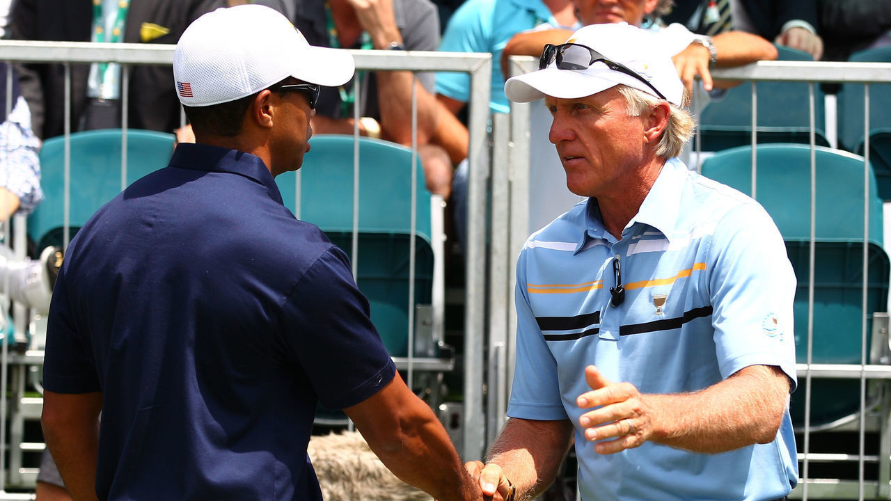 MELBOURNE, AUSTRALIA - NOVEMBER 17: (L-R) Tiger Woods of the U.S. Team and International Team captain Greg Norman shake hands on the first hole during the Day One Foursome Matches of the 2011 Presidents Cup at Royal Melbourne Golf Course on November 17, 2011 in Melbourne, Australia.