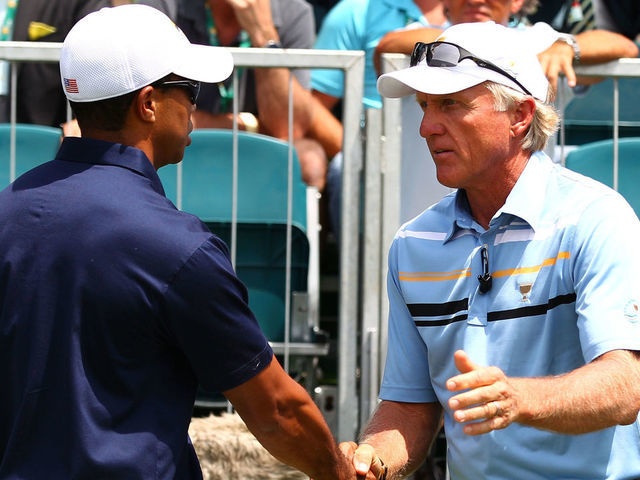 MELBOURNE, AUSTRALIA - NOVEMBER 17: (L-R) Tiger Woods of the U.S. Team and International Team captain Greg Norman shake hands on the first hole during the Day One Foursome Matches of the 2011 Presidents Cup at Royal Melbourne Golf Course on November 17, 2011 in Melbourne, Australia.
