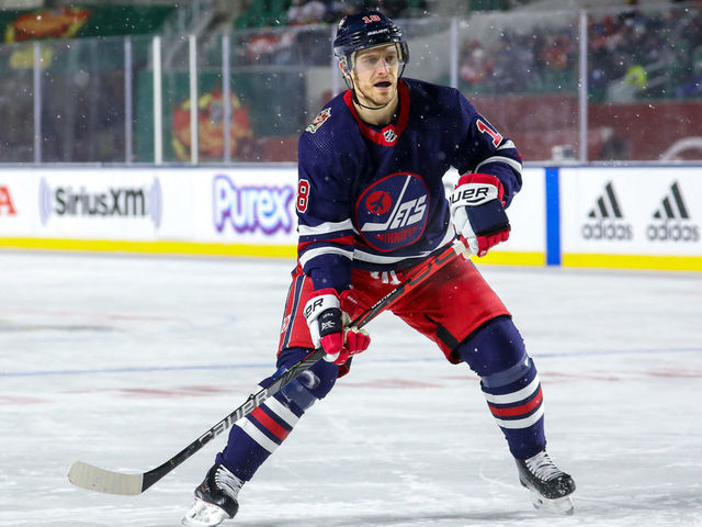 REGINA, SK - OCTOBER 26: Bryan Little #18 of the Winnipeg Jets keeps an eye on the play during third period action against the Calgary Flames during the 2019 Tim Hortons NHL Heritage Classic at Mosaic Stadium on October 26, 2019 in Regina, Saskatchewan, Canada. The Jets defeated the Flames 2-1 in overtime.