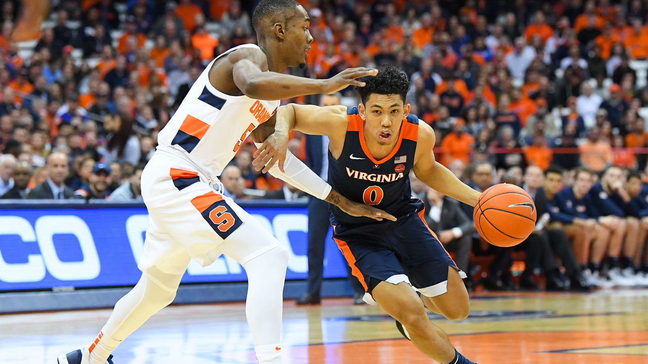 SYRACUSE, NY - NOVEMBER 06: Kihei Clark #0 of the Virginia Cavaliers drives to the basket against the defense of Jalen Carey #5 of the Syracuse Orange during the first half at the Carrier Dome on November 6, 2019 in Syracuse, New York.