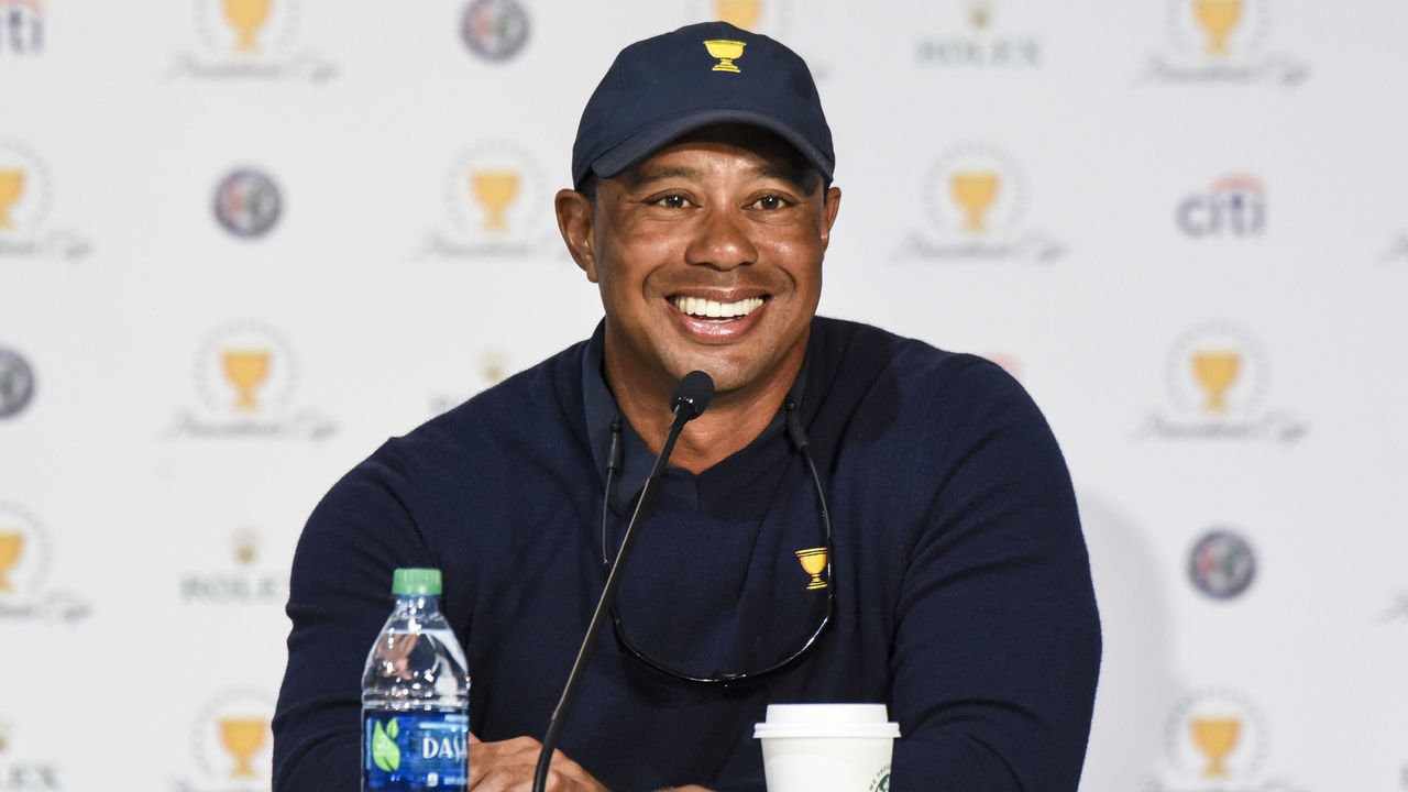 JERSEY CITY, NJ - OCTOBER 01: Captain's Assistant Tiger Woods of the U.S. Team smiles during a press conference following the team's victory after Sunday Singles matches at the Presidents Cup at Liberty National Golf Club on October 1, 2017, in Jersey City, New Jersey.