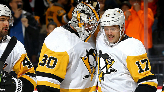 NEW YORK, NEW YORK - NOVEMBER 07: Bryan Rust #17 of the Pittsburgh Penguins is congratulated by his teammate Matt Murray #30 after scoring a game-winning goal against the New York Islanders during overtime at Barclays Center on November 07, 2019 in New York City.