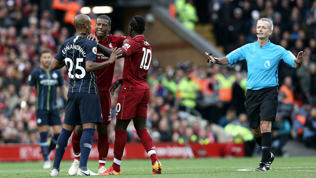 LIVERPOOL, ENGLAND - OCTOBER 07: Liverpool's Georginio Wijnaldum separates Sadio Mane and Manchester City's Fernandinho following an altercation while Referee Martin Atkinson makes his way over during the Premier League match between Liverpool FC and Manchester City at Anfield on October 7, 2018 in Liverpool, United Kingdom.