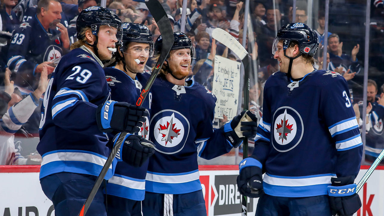 WINNIPEG, MB - NOVEMBER 8: Patrik Laine #29, Mark Scheifele #55, Kyle Connor #81 and Tucker Poolman #3 of the Winnipeg Jets celebrate a second period goal against the Vancouver Canucks at the Bell MTS Place on November 8, 2019 in Winnipeg, Manitoba, Canada.