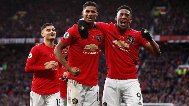 Manchester United's Marcus Rashford celebrates scoring his side's third goal of the game with Anthony Martial (right) during the Premier League match at Old Trafford, Manchester.