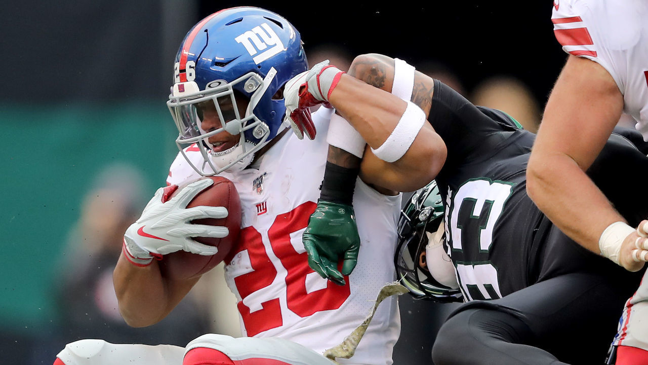 EAST RUTHERFORD, NEW JERSEY - NOVEMBER 10: Saquon Barkley #26 of the New York Giants is stopped by Jamal Adams #33 of the New York Jets at MetLife Stadium on November 10, 2019 in East Rutherford, New Jersey.
