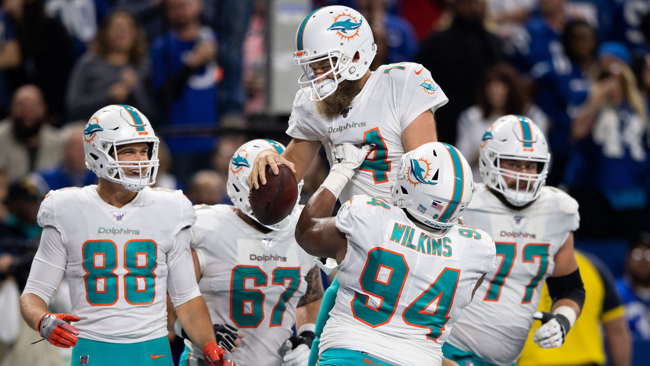 INDIANAPOLIS, IN - NOVEMBER 10: Miami Dolphins quarterback Ryan Fitzpatrick (14) and Miami Dolphins defensive tackle Christian Wilkins (94) celebrate a touchdown during the NFL game between the Miami Dolphins and the Indianapolis Colts on November 10, 2019 at Lucas Oil Stadium, in Indianapolis, IN.