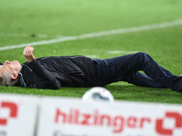 FREIBURG IM BREISGAU, GERMANY - NOVEMBER 10: Headcoach Christian Streich of SC Freiburg lying on pitch after a check during the Bundesliga match between Sport-Club Freiburg and Eintracht Frankfurt at Schwarzwald-Stadion on November 10, 2019 in Freiburg im Breisgau, Germany.