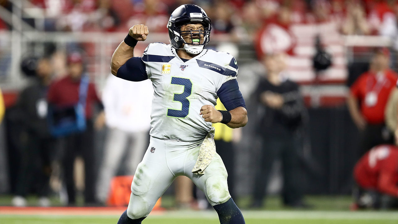 SANTA CLARA, CALIFORNIA - NOVEMBER 11: Quarterback Russell Wilson #3 of the Seattle Seahawks celebrates the touchdown by running back Chris Carson #32 in the third quarter against the San Francisco 49ers at Levi's Stadium on November 11, 2019 in Santa Clara, California.