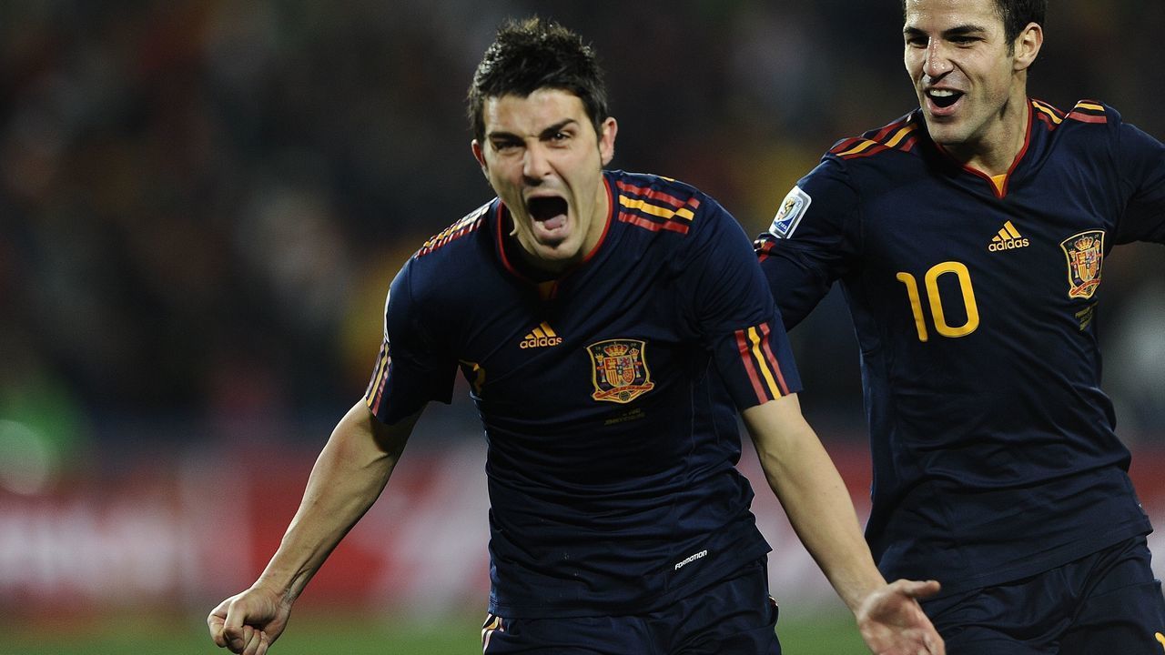 Spain's striker David Villa (L) celebrates after he scored a goal as Spain's midfielder Cesc Fabregas joins him during the quarter final 2010 World Cup match Paraguay versus Spain on July 3, 2010 at Ellis Park stadium in Johannesburg. NO PUSH TO MOBILE / MOBILE USE SOLELY WITHIN EDITORIAL ARTICLE - AFP PHOTO / JUAN MABROMATA