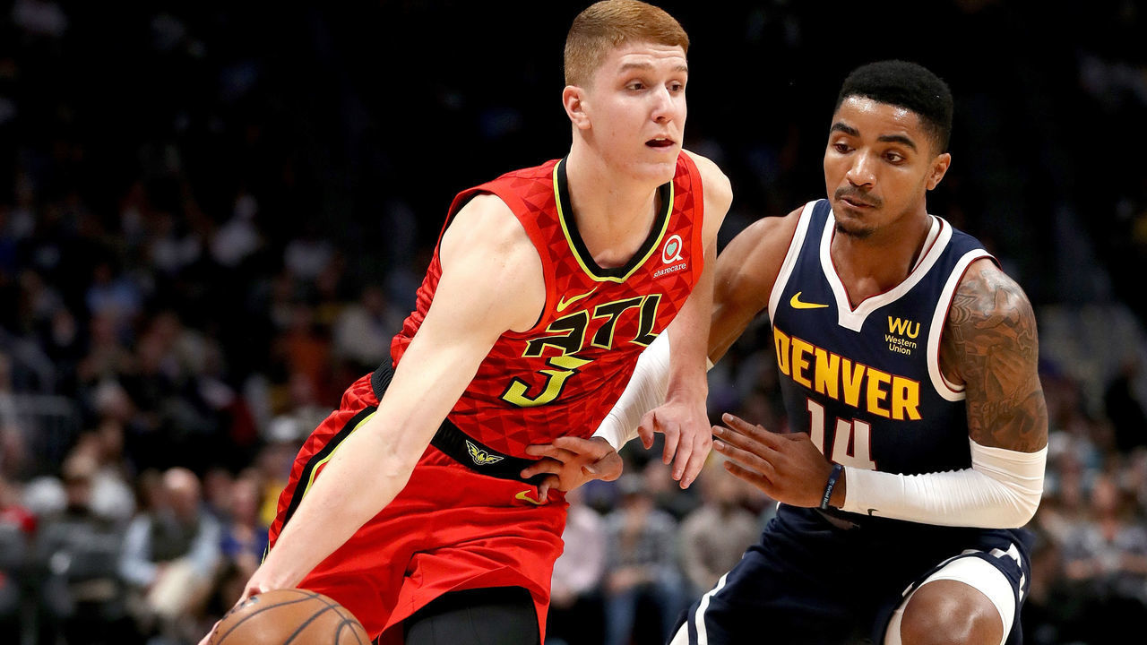 DENVER, COLORADO - NOVEMBER 12: Kevin Huerter #3 of the Atlanta Hawks drives against Gary Harris #14 of the Denver Nuggets in the first quarter at the Pepsi Center on November 12, 2019 in Denver, Colorado.
