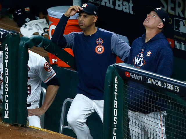 HOUSTON, TX - OCTOBER 29: Bench coach Alex Cora #26 and manager A.J. Hinch #14 of the Houston Astros look on from the dugout during the fifth inning against the Los Angeles Dodgers in game five of the 2017 World Series at Minute Maid Park on October 29, 2017 in Houston, Texas.