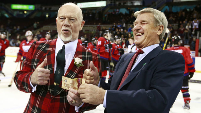 VANCOUVER, BC - JANUARY 28: Team Cherry coach Don Cherry hands over a $100 bill to Team Orr coach Bobby Orr after losing a game winning bet at the CHL/NHL Top Prospects Game January 28, 2016 at Pacific Coliseum in Vancouver, British Columbia, Canada. Team Orr defeated Team Cherry 3-2.