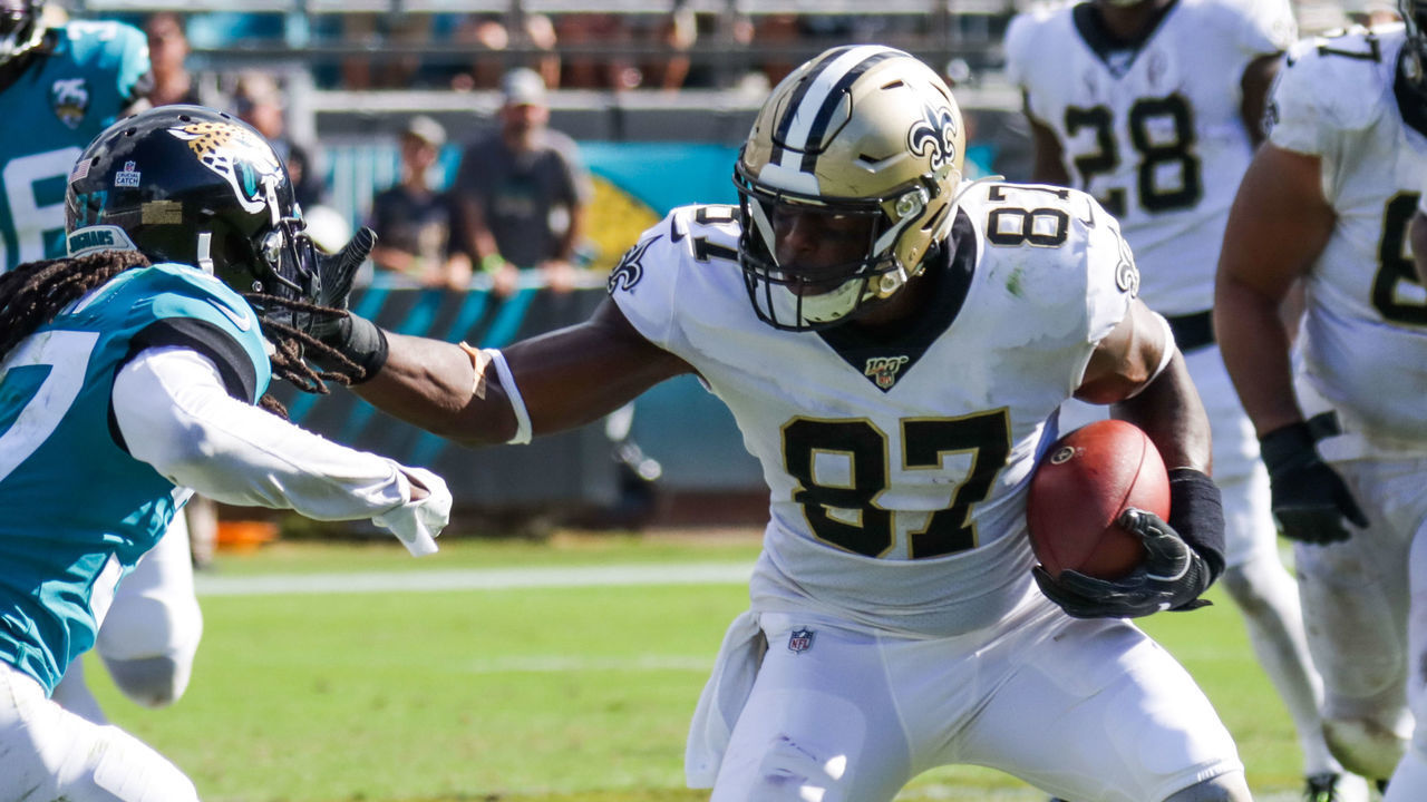 JACKSONVILLE, FLORIDA - OCTOBER 13: Jared Cook #87 of the New Orleans Saints attempts to pass Tre Herndon #37 of the Jacksonville Jaguars in the 4th quarter at TIAA Bank Field on October 13, 2019 in Jacksonville, Florida.