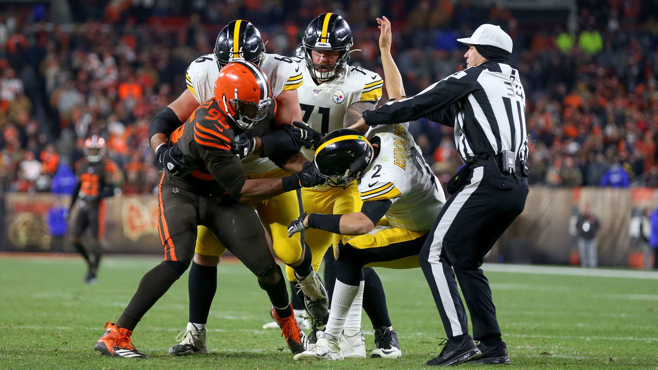 CLEVELAND, OH - NOVEMBER 14: Cleveland Browns defensive end Myles Garrett (95) attempts to remove the helmet of Pittsburgh Steelers quarterback Mason Rudolph (2) as Pittsburgh Steelers offensive guard David DeCastro (66), Pittsburgh Steelers offensive tackle Matt Feiler (71) and referee Clete Blakeman (34) come to Rudolphs aid during the fourth quarter of the National Football League game between the Pittsburgh Steelers and Cleveland Browns on November 14, 2019, at FirstEnergy Stadium in Cleveland, OH.
