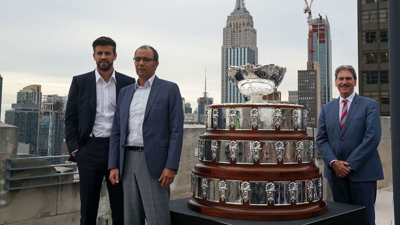 Kosmoa Founder and President Gerard Pique (L), Spain Consul for Tourism Affairs Jose Manuel de Juan (C) and ITF President David Haggerty pose with the Davis Cup Trophy on September 5, 2019 in New York.