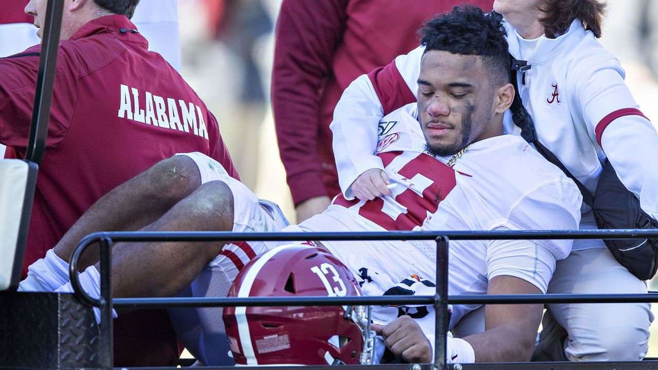 FAYETTEVILLE, AR - NOVEMBER 9: Tua Tagovailoa #13 of the Alabama Crimson Tide is helped off the field after being injured on a play in the first half of a game against the Mississippi State Bulldogs at Davis Wade Stadium on November 16, 2019 in Starkville, Mississippi.