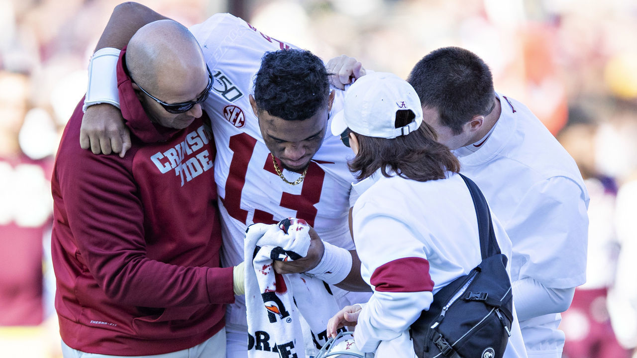 FAYETTEVILLE, AR - NOVEMBER 9: Tua Tagovailoa #13 of the Alabama Crimson Tide is helped off the field after being injured on a play in the first half of a game against the Mississippi State Bulldogs at Davis Wade Stadium on November 16, 2019 in Starkville, Mississippi.