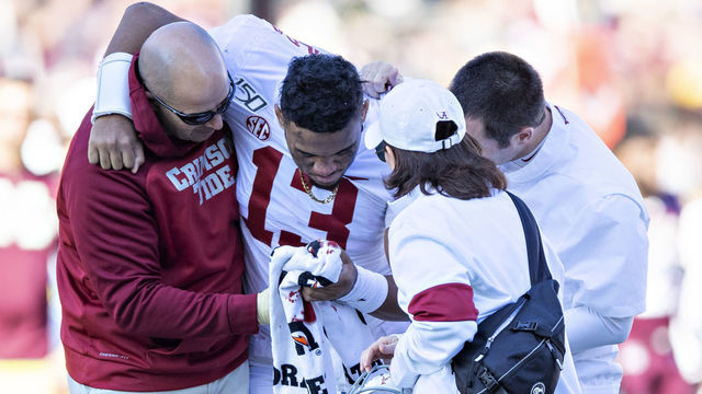 FAYETTEVILLE, AR - NOVEMBER 9: Tua Tagovailoa #13 of the Alabama Crimson Tide is helped off the field after being injured on a play in the first half of a game against the Mississippi State Bulldogs at Davis Wade Stadium on November 16, 2019 in Starkville, Mississippi.