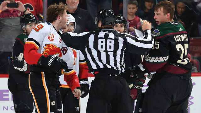 GLENDALE, ARIZONA - NOVEMBER 16: Linesman Tyson Baker #88 separates Matthew Tkachuk #19 of the Calgary Flames and goalie Darcy Kuemper #35 of the Arizona Coyotes after a scuffle during the second period at Gila River Arena on November 16, 2019 in Glendale, Arizona.