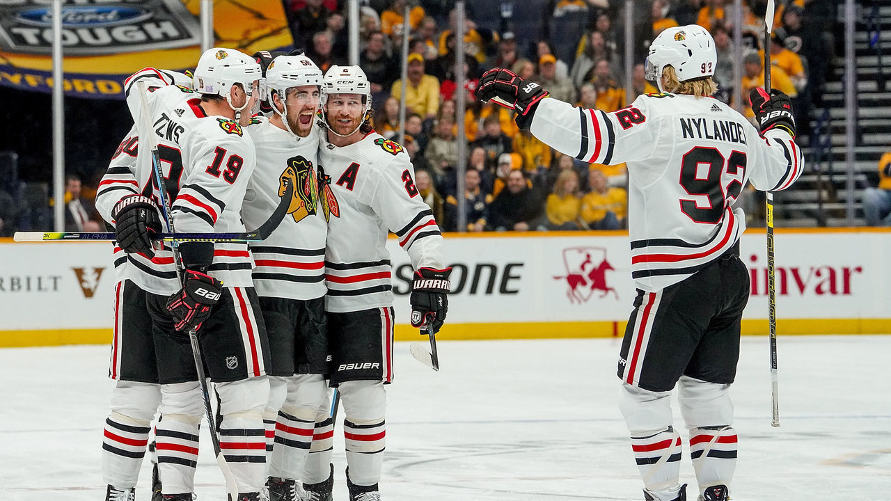 NASHVILLE, TN - NOVEMBER 16: Erik Gustafsson #56 of the Chicago Blackhawks celebrates his goal with teammates against the Nashville Predators at Bridgestone Arena on November 16, 2019 in Nashville, Tennessee.