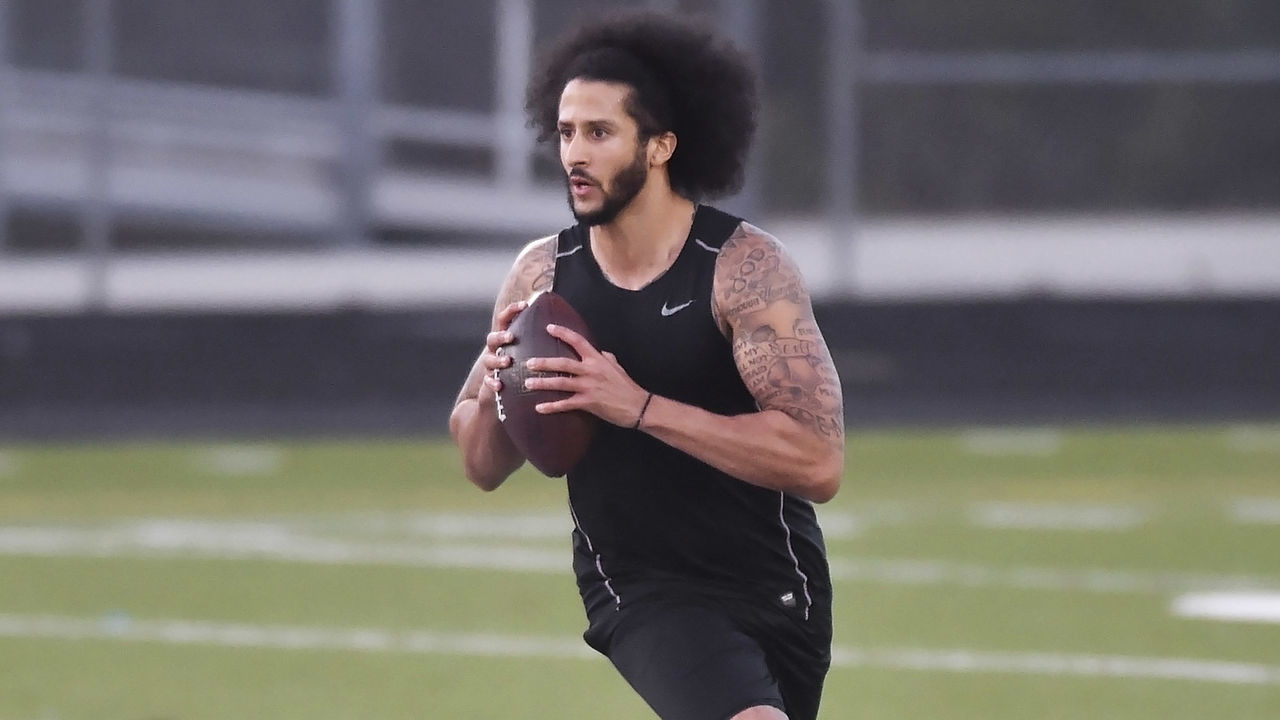 RIVERDALE, GA - NOVEMBER 16: Former NFL quarterback Colin Kaepernick rolls out while looking downfield while going through a series of passing drills at Southern Crescent Stadium at Charles R. Drew High School.