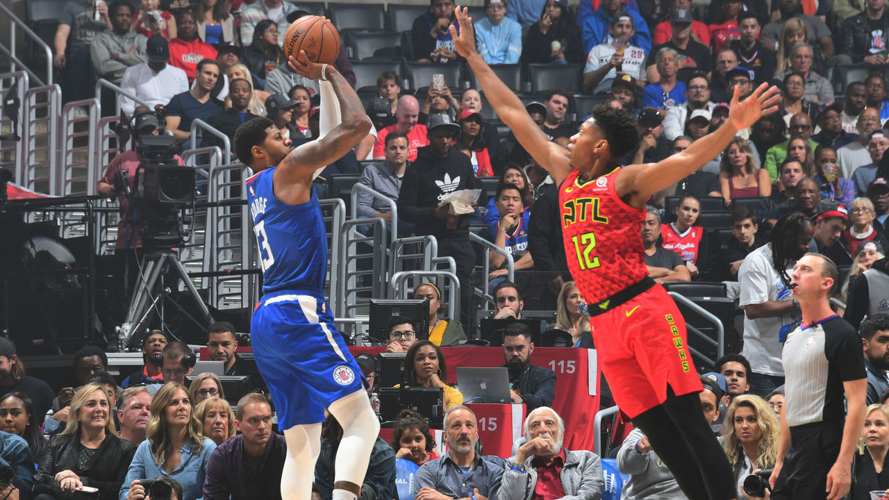 ATLANTA, GA - NOVEMBER 16: Paul George #13 of the LA Clippers shoots the ball against De'Andre Hunter #12 of the Atlanta Hawkson November 16, 2019 at State Farm Arena in Atlanta, Georgia. NOTE TO USER: User expressly acknowledges and agrees that, by downloading and/or using this Photograph, user is consenting to the terms and conditions of the Getty Images License Agreement. Mandatory Copyright Notice: Copyright 2019 NBAE