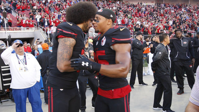 SANTA CLARA, CA - OCTOBER 6: Colin Kaepernick #7 and Eric Reid #35 of the San Francisco 49ers embrace on the sideline, following the anthem, prior to the game against the Arizona Cardinals at Levi Stadium on October 6, 2016 in Santa Clara, California. The Cardinals defeated the 49ers 33-21.