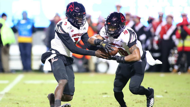 RALEIGH, NC - NOVEMBER 16: Louisville Cardinals quarterback Micale Cunningham (3) passes the ball to Louisville Cardinals running back Javian Hawkins (10) during the 1st half of the NC State Wolfpack game versus the Louisville Cardinals on November 16th, 2019 at Carter-Finley Stadium in Raleigh, NC.