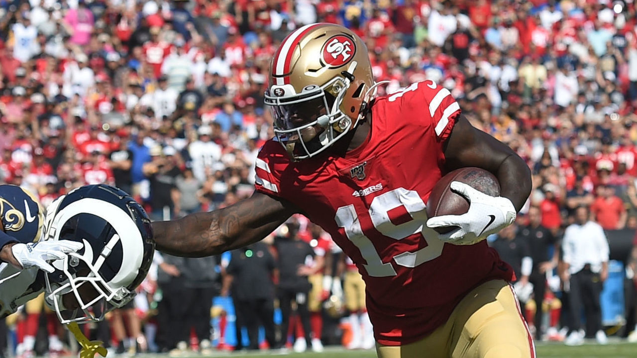 LOS ANGELES, CA - OCTOBER 13: San Francisco 49ers Wide Receiver Deebo Samuel (19) stiff arms Los Angeles Rams Cornerback Troy Hill (20) during an NFL game between the San Francisco 49ers and the Los Angeles Rams on October 13, 2019, at the Los Angeles Memorial Coliseum in Los Angeles, CA.