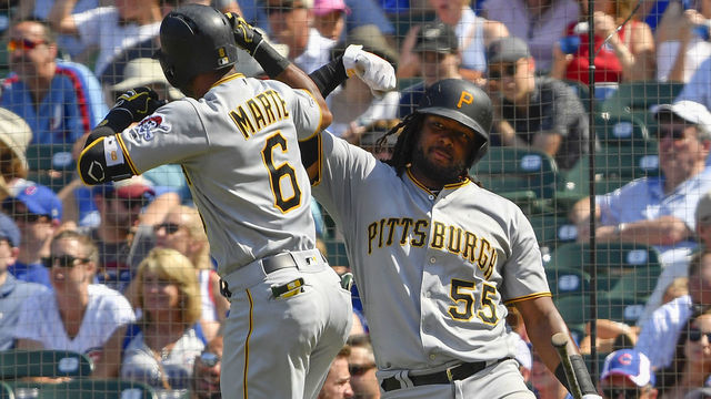 CHICAGO, ILLINOIS - JULY 13: Josh Bell #55 of the Pittsburgh Pirates celebrates Starling Marte #6 of the Pittsburgh Pirates for his solo home run in the sixth inning against the Chicago Cubs at Wrigley Field on July 13, 2019 in Chicago, Illinois.
