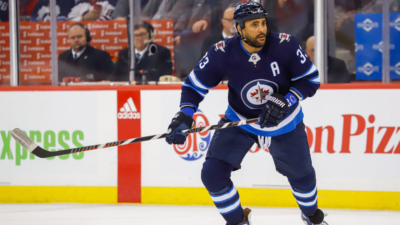 WINNIPEG, MB - MARCH 30: Dustin Byfuglien #33 of the Winnipeg Jets keeps an eye on the play during first period action against the Montreal Canadiens at the Bell MTS Place on March 30, 2019 in Winnipeg, Manitoba, Canada. The Habs defeated the Jets 3-1.