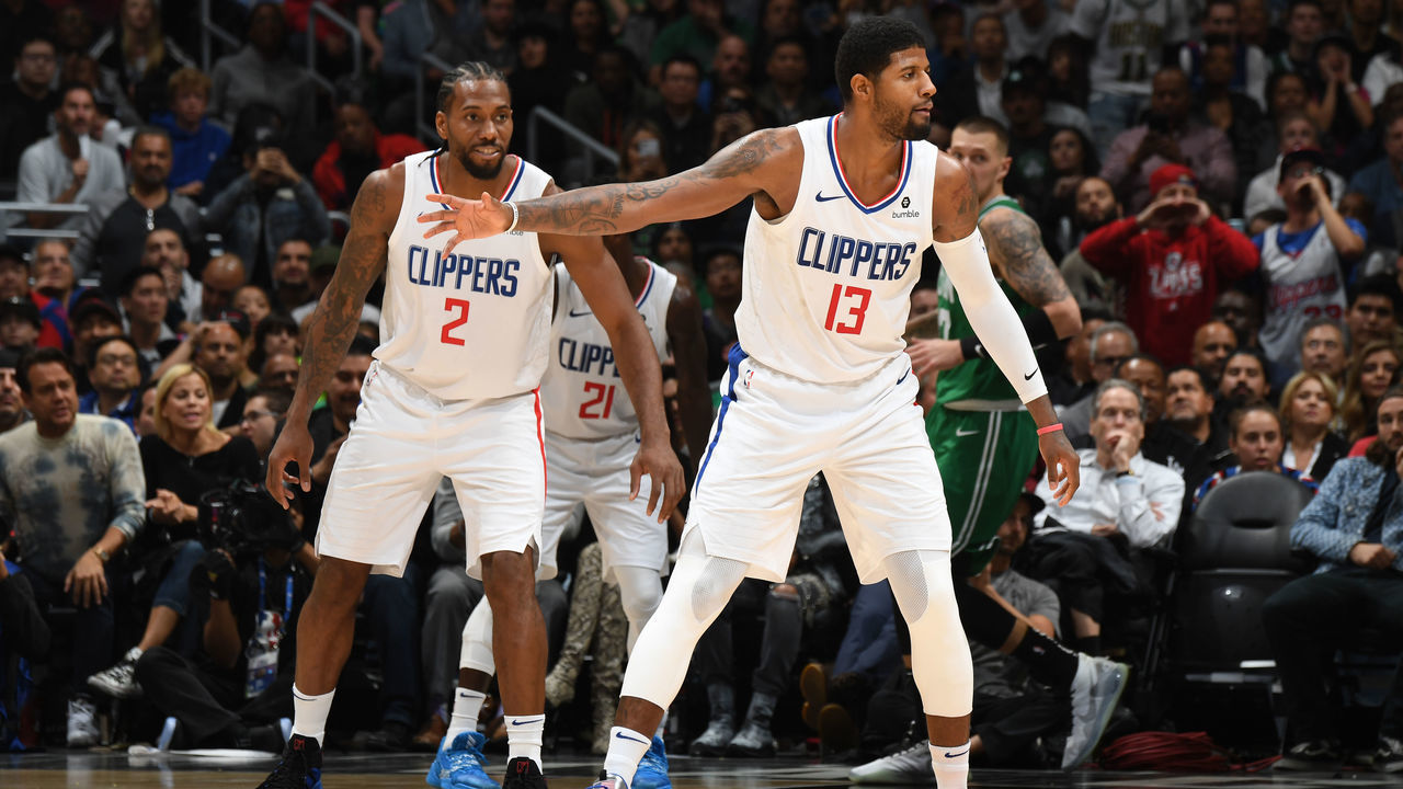LOS ANGELES, CA - NOVEMBER 20: Kawhi Leonard #2, and Paul George #13 of the LA Clippers react to a play against the Boston Celtics on November 20, 2019 at STAPLES Center in Los Angeles, California. NOTE TO USER: User expressly acknowledges and agrees that, by downloading and/or using this Photograph, user is consenting to the terms and conditions of the Getty Images License Agreement. Mandatory Copyright Notice: Copyright 2019 NBAE