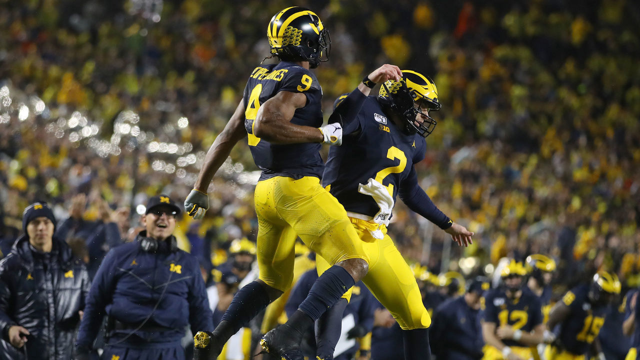 ANN ARBOR, MICHIGAN - OCTOBER 26: Donovan Peoples-Jones #9 of the Michigan Wolverines celebrates his second half touchdown catch with Shea Patterson #2 in front of head coach Jim Harbaugh while playing the Notre Dame Fighting Irish at Michigan Stadium on October 26, 2019 in Ann Arbor, Michigan. Michigan won the game 45-14.