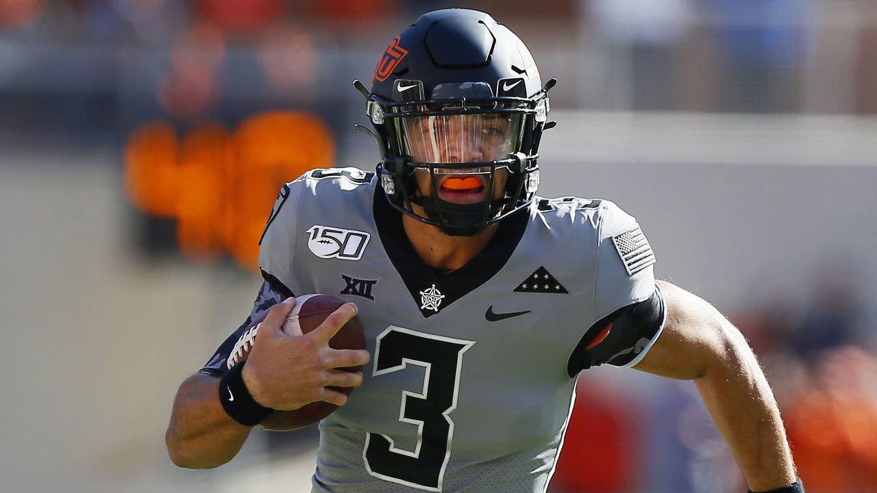 STILLWATER, OK - NOVEMBER 16: Quarterback Spencer Sanders #3 of the Oklahoma State Cowboys keeps the ball for a 14-yard run to set up a touchdown against the Kansas Jayhawks in the first quarter on November 16, 2019 at Boone Pickens Stadium in Stillwater, Oklahoma. OSU won 31-13.