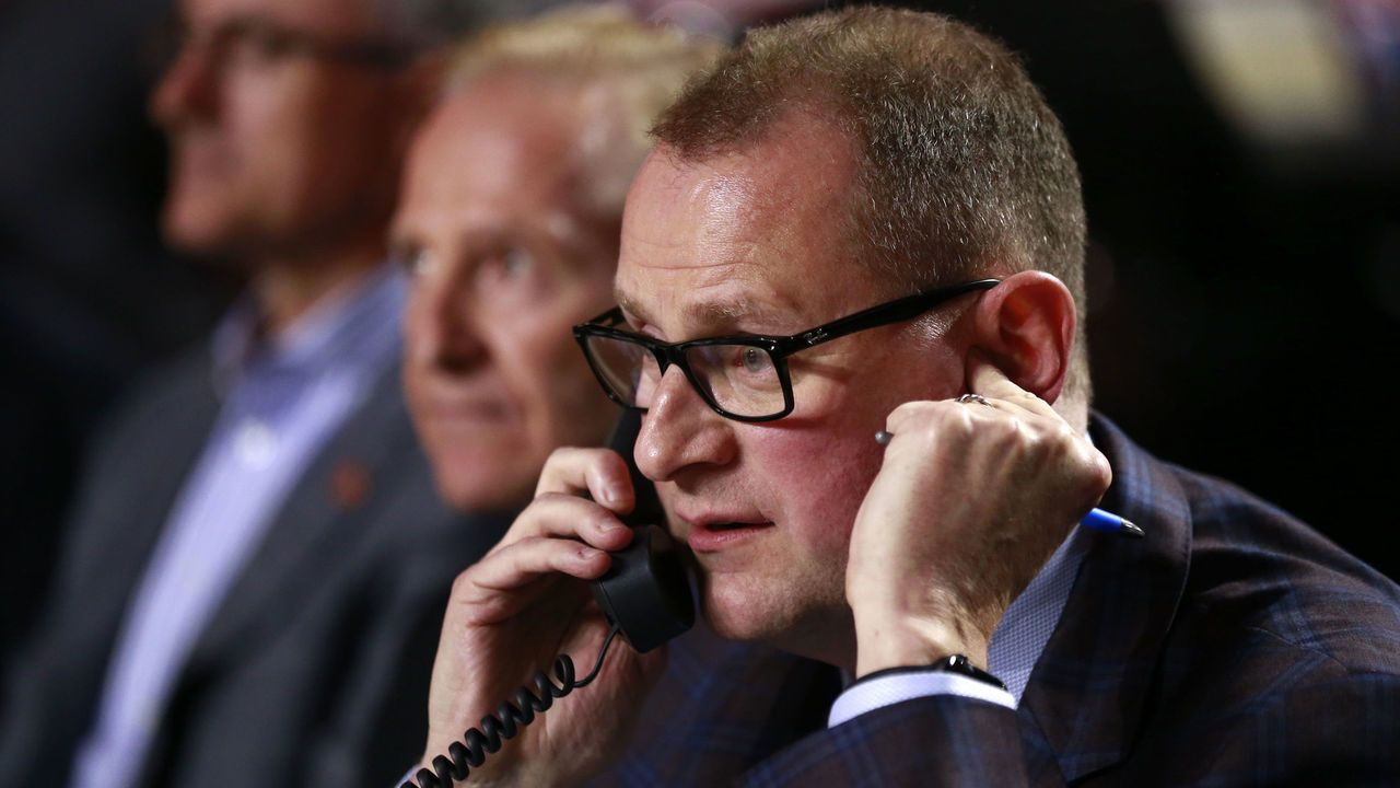 VANCOUVER, BRITISH COLUMBIA - JUNE 21: General manager Brad Treliving of the Calgary Flames talks on the phone from the team draft table during the first round of the 2019 NHL Draft at Rogers Arena on June 21, 2019 in Vancouver, Canada.