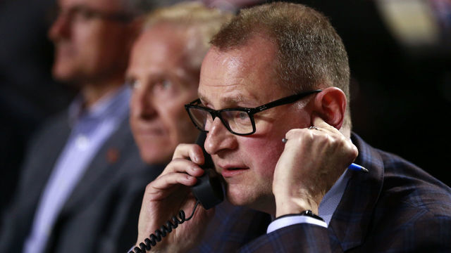 VANCOUVER, BRITISH COLUMBIA - JUNE 21: General manager Brad Treliving of the Calgary Flames talks on the phone from the team draft table during the first round of the 2019 NHL Draft at Rogers Arena on June 21, 2019 in Vancouver, Canada.