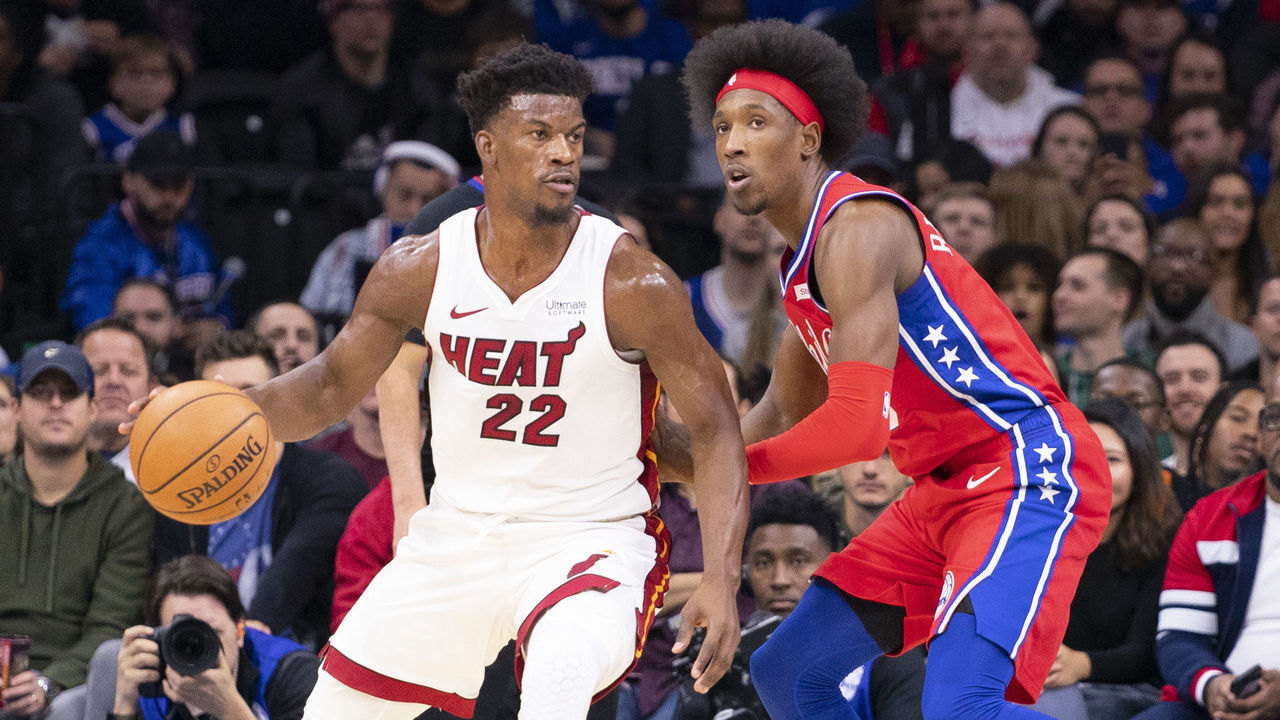 PHILADELPHIA, PA - NOVEMBER 23: Jimmy Butler #22 of the Miami Heat dribbles the ball against Josh Richardson #0 of the Philadelphia 76ers in the first quarter at the Wells Fargo Center on November 23, 2019 in Philadelphia, Pennsylvania. NOTE TO USER: User expressly acknowledges and agrees that, by downloading and/or using this photograph, user is consenting to the terms and conditions of the Getty Images License Agreement.
