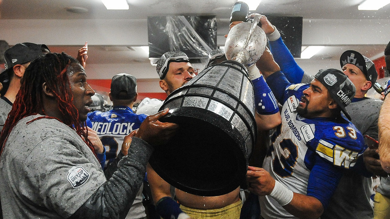 CALGARY, AB - NOVEMBER 24: Andrew Harris #33 (R) of the Winnipeg Blue Bombers celebrates with his teammates after defeating the Hamilton Tiger-Cats during the 107th Grey Cup Championship Game at McMahon Stadium on November 24, 2019 in Calgary, Alberta, Canada.
