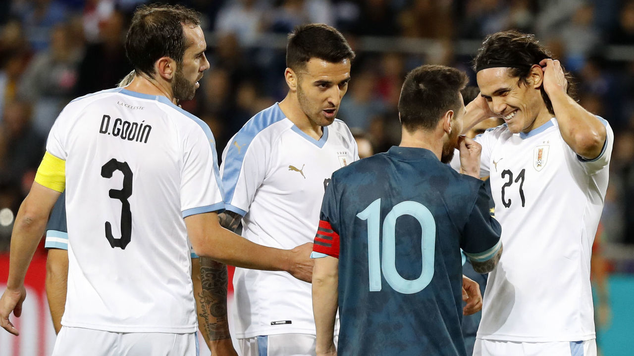Argentina's forward Lionel Messi talks to Uruguay's forward Edinson Cavani during the friendly football match between Argentina and Uruguay at the Bloomfield stadium in the Israeli coastal city of Tel Aviv on November 18, 2019.