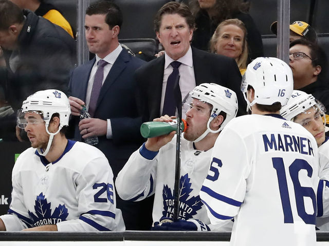 BOSTON, MA - OCTOBER 22: Toronto Maple Leafs head coach Mike Babcock talks to Toronto Maple Leafs right wing Mitchell Marner (16) during a game between the Boston Bruins and the Toronto Maple Leafs on October 22, 2019, at TD Garden in Boston, Massachusetts.