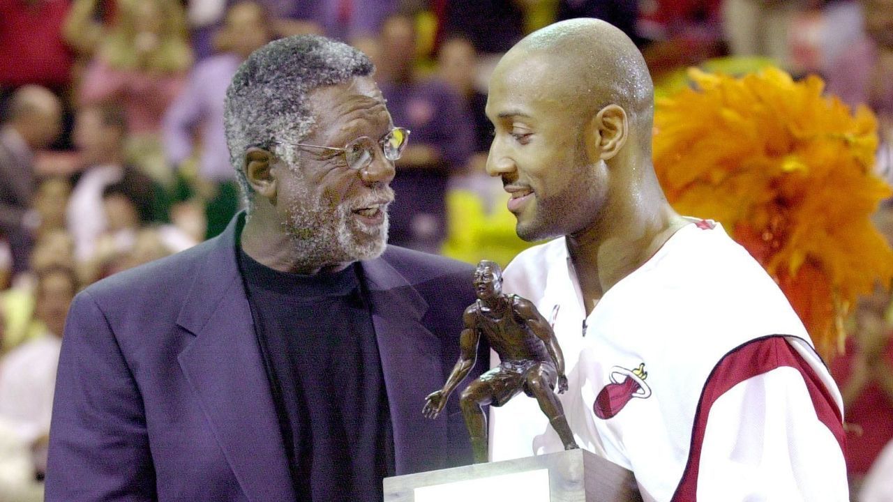 MIAMI, UNITED STATES: Alonzo Mourning of the Miami Heat (R) smiles as he receives the trophy from basketball legend Bill Russell (L) after Mourning was named Defensive Player of the Year by the NBA before his team's fifth Eastern conference semi-final series game against the New York Knicks at the American Airlines Arena in Miami 17 May 2000. ELECTRONIC IMAGE AFP PHOTO RHONA WISE