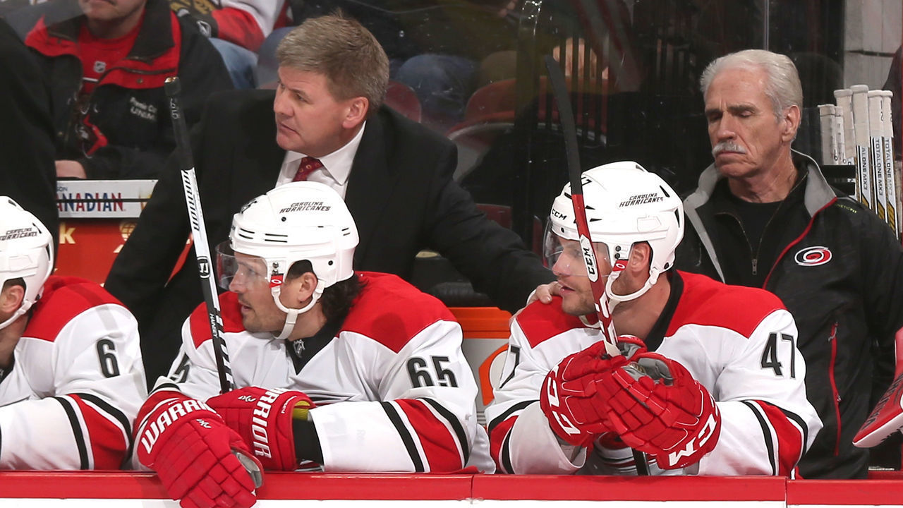 OTTAWA, ON - FEBRUARY 16: Head coach Bill Peters of the Carolina Hurricanes pats Michal Jordan #47 on the shoulder after the latter scored his first career NHL goal in a game against the Ottawa Senators at Canadian Tire Centre on February 16, 2015 in Ottawa, Ontario, Canada.