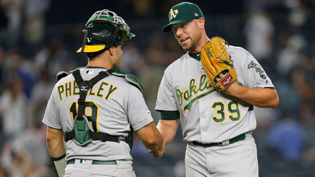 NEW YORK, NY - AUGUST 30: Closer Blake Treinen #39 of the Oakland A's is congratulated by catcher Josh Phegley #19 after their 8-2 win over the New York Yankees during a game at Yankee Stadium on August 30, 2019 in New York City.