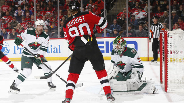 NEWARK, NJ - NOVEMBER 26: Kaapo Kahkonen #31 of the Minnesota Wild playing in his first NHL game defends his net against Jesper Boqvist #90 of the New Jersey Devils during the game at the Prudential Center on November 26, 2019 in Newark, New Jersey. The Wild defeated the Devils 3-2.