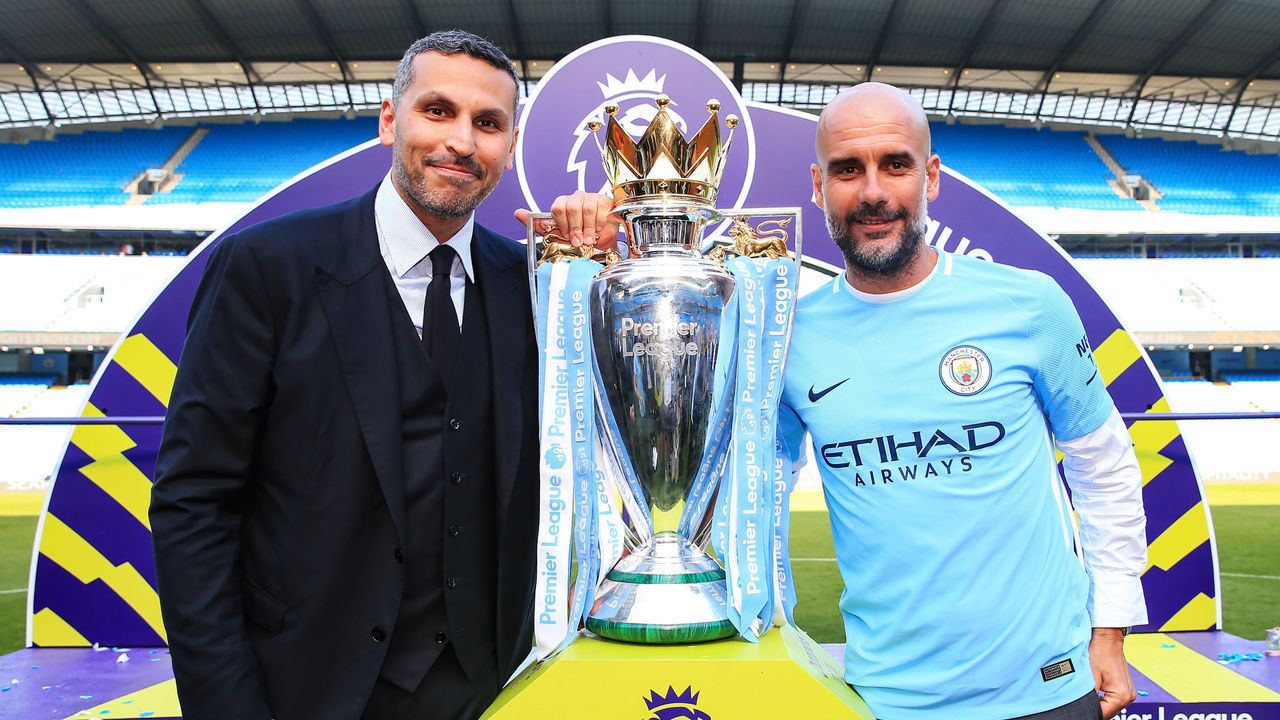 MANCHESTER, ENGLAND - MAY 06: Manchester City chairman Khaldoon Al Mubarak poses with manager Pep Guardiola and the Premier League trophy after the Premier League match between Manchester City and Huddersfield Town at Etihad Stadium on May 6, 2018 in Manchester, England.