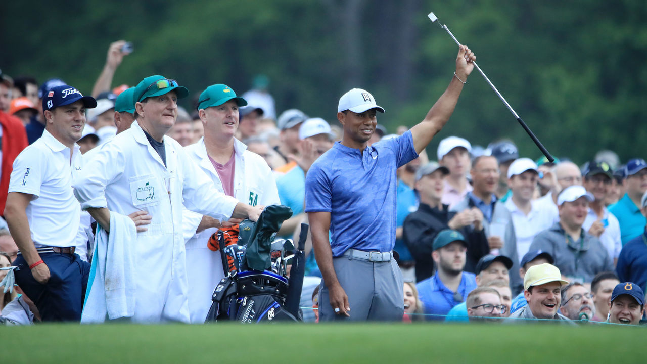 AUGUSTA, GEORGIA - APRIL 08: Tiger Woods of the United States reacts to his shot on the 12th tee as caddie Joe LaCava and Justin Thomas of the United States look on during a practice round prior to The Masters at Augusta National Golf Club on April 08, 2019 in Augusta, Georgia.