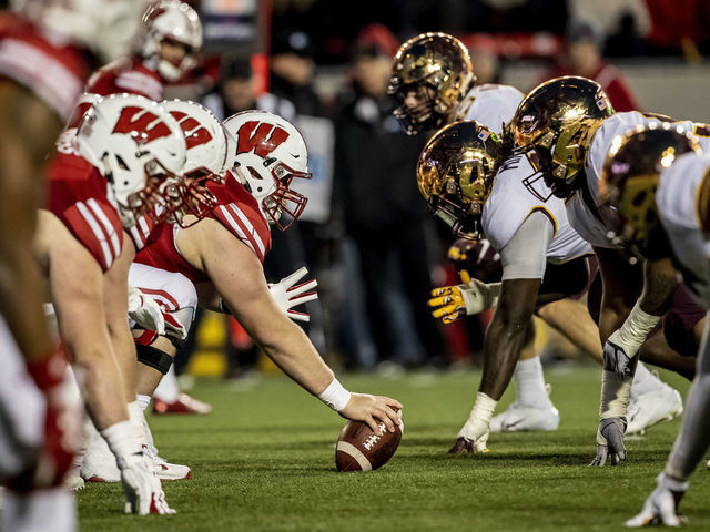 MADISON, WI - NOVEMBER 24: Wisconsin Badger offensive line reads to snap the ball against the Minnesota Golden Gopher defense during an college football game between the Minnesota Golden Gophers and the Wisconsin Badgers on November 24th, 2018 at the Camp Randall Stadium in Madison, WI. Minnesota defeats Wisconsin 37-15 to win Paul Bunyan Axe.