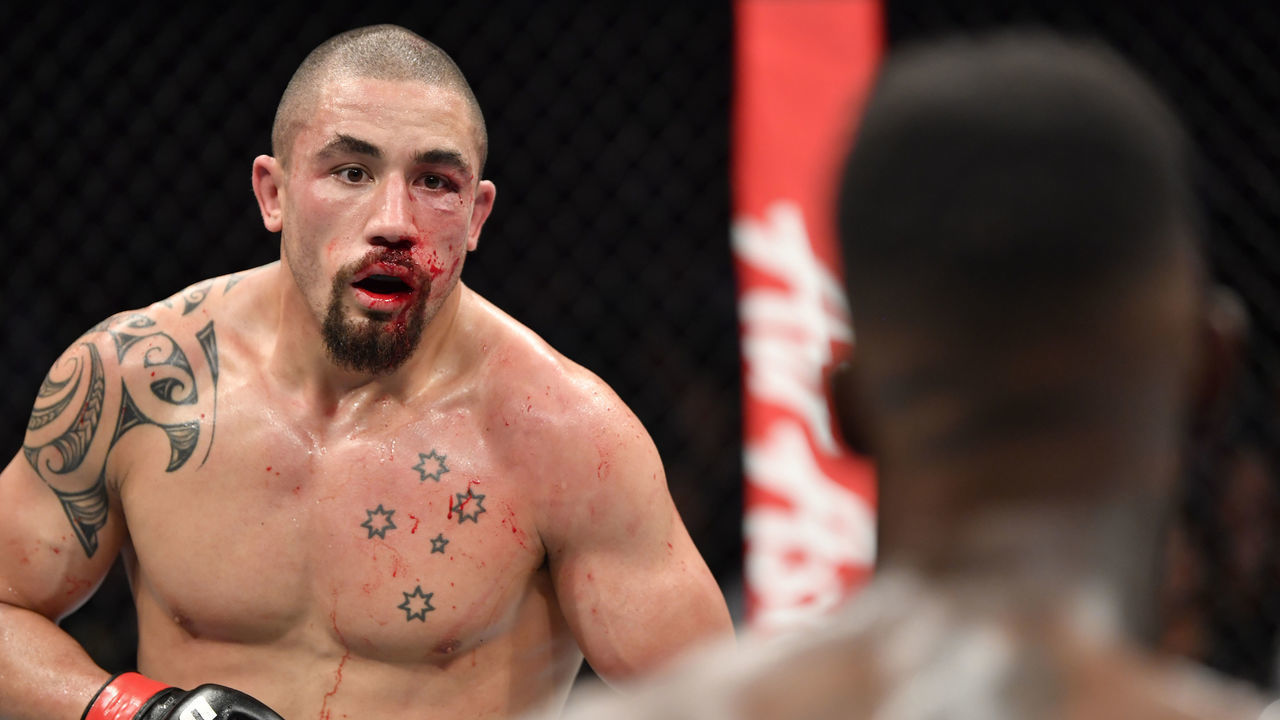 MELBOURNE, AUSTRALIA - OCTOBER 06: (L-R) Robert Whittaker of New Zealand battles Israel Adesanya of Nigeria in their UFC middleweight championship fight during the UFC 243 event at Marvel Stadium on October 06, 2019 in Melbourne, Australia.